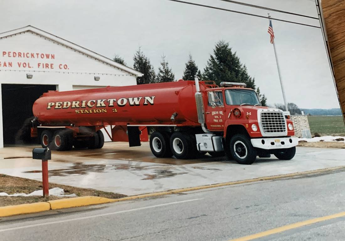 Tanker truck parked in front of station